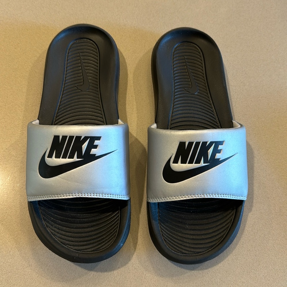 Brand new, never worn. Nike silver and black slides. Size W7
